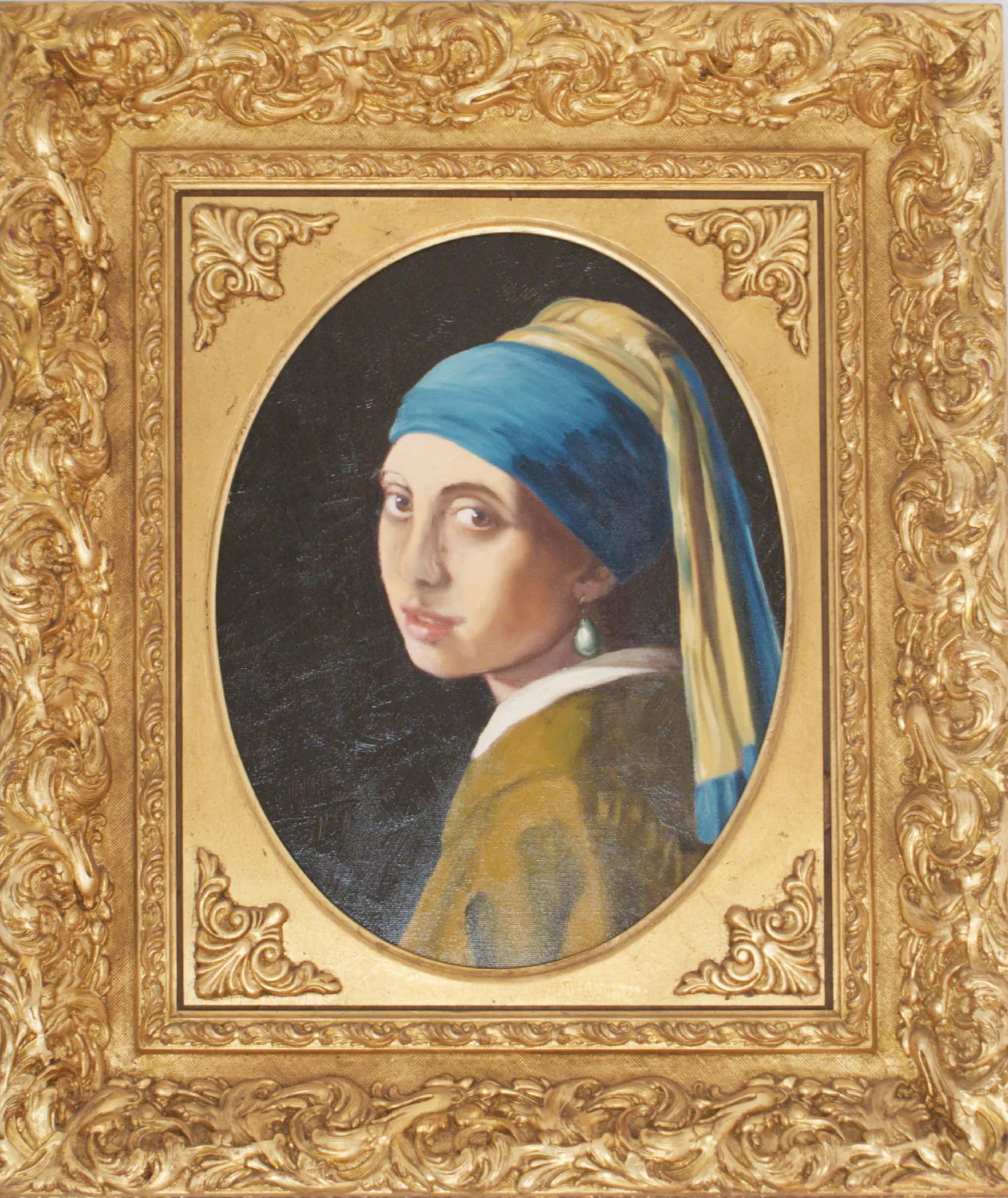 Girl-with-a-pearl-earring-Aly-Mohsen "Painting by Aly Mohsen, executed in Oil on canvas (brush). The title is Girl with a pearl earring and it belongs to the category Portraits. In Girl with a Pearl Earring, Aly Mohsen presents a study copy inspired by one of the most celebrated masterpieces of 17th-century Dutch painting, engaging thoughtfully with the legacy of Jan Vermeer. The work belongs to the European figurative tradition as an exercise in formal, luminous, and expressive analysis. The young figure is captured in a slight turn of the head, suspended in a timeless moment that establishes a direct visual dialogue with the viewer. Her luminous gaze and gently parted lips create an image rich in emotional tension, devoid of explicit narrative yet deeply evocative. The subject’s identity remains intentionally undefined, transforming her into a universal icon of introspection and quiet mystery. Light plays a central role in the composition, rendered softly and envelopingly as it models the face and highlights the pearl earring. Subtle chiaroscuro transitions shape the volumes with restraint and naturalism. The dark, neutral background isolates the figure, intensifying her visual presence and focusing attention on expression and painterly quality. The chromatic palette is balanced and restrained: the deep blue of the headscarf interacts with warm yellows and soft flesh tones, while the pearl functions as a luminous focal point and symbolic element. Mohsen’s brushwork is controlled and analytical, aimed at studying form, surface, and tonal transitions. The painting is enclosed in a wide, finely carved gilded frame, recalling the historical European exhibition tradition and lending the work a museum-quality presence, enhancing the contrast between ornamental richness and the essential simplicity of the subject."