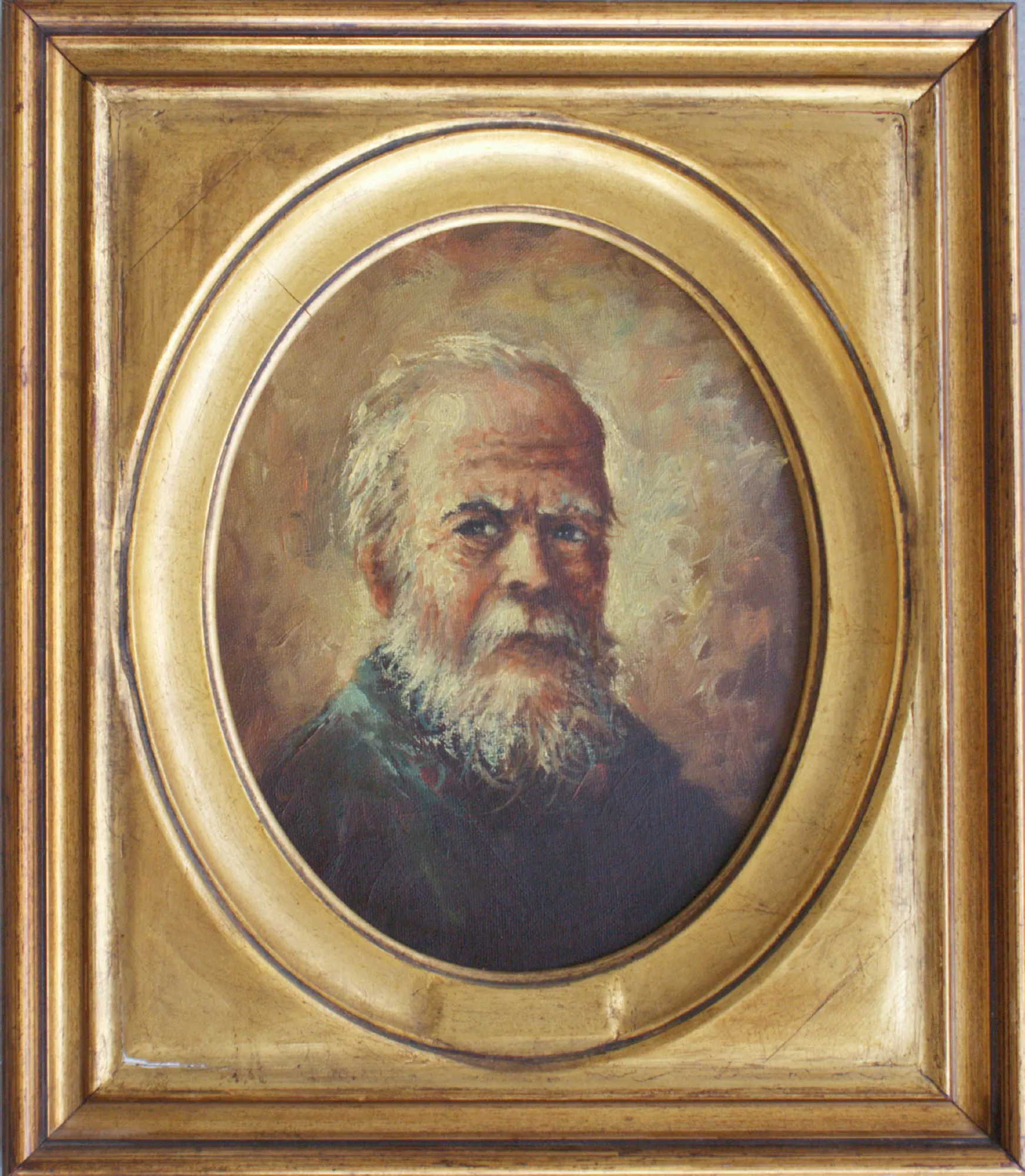 Portrait-of-an-elderly-man-Aly-Mohsen "Painting by Aly Mohsen, executed in Oil on canvas (brush). The title is Portrait of an elderly man and it belongs to the category Portraits. In Portrait of an Elderly Man, Aly Mohsen presents an intense and timeless representation of the human figure, focusing his pictorial inquiry on the face as a privileged site of memory, experience, and the dignity of age. The subject is depicted half-length within an oval composition that recalls the tradition of classical portraiture, and meets the viewer with a direct, profound gaze charged with introspection. The face—marked by wrinkles, a full beard, and gray hair—is rendered with great figurative sensitivity through a brushwork that is measured yet incisive, capable of suggesting the texture of the skin and the fragility of advanced age without excessive descriptive emphasis. The expression, severe yet composed, conveys strong humanity and a sense of quiet wisdom. The chromatic palette is dominated by warm, earthy tones that envelop the figure in an intimate and concentrated atmosphere. The background, deliberately softened and free of narrative elements, isolates the subject and reinforces the psychological centrality of the portrait. Light is diffused and controlled, shaping the facial volumes with classical balance and avoiding dramatic effects. The gilded frame, harmonizing with the oval format of the image, recalls the tradition of historical portraiture and lends the work a solemn and timeless character, strengthening the connection between historical memory and contemporary sensibility. Portrait of an Elderly Man fits coherently within Aly Mohsen’s figurative research devoted to the exploration of the human condition, offering an image of strong emotional intensity and expressive clarity, grounded in the depth of the gaze and the dignity of human presence."