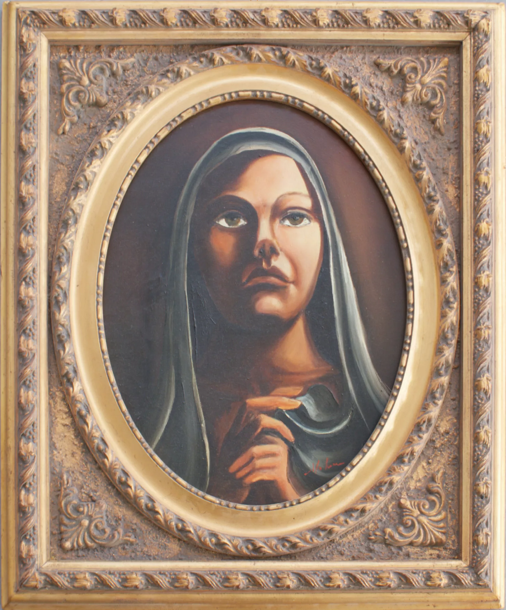 Portrait-of-a-woman-Aly-Mohsen "Painting by Aly Mohsen, executed in Oil on canvas (brush). The title is Portrait of a woman and it belongs to the category Portraits. In Portrait of a Woman, Aly Mohsen creates an intense and inward-looking image in which the female figure takes on a solemn and timeless character. The face, set within an oval composition, emerges from a dark, uniform background, creating a strong contrast that focuses attention on expression and gaze. The woman is depicted frontally, with her head covered by a veil that frames the face and enhances its monumentality. Her large, deep eyes establish a direct dialogue with the viewer, conveying a sense of introspection, silence, and spiritual interiority. The gesture of the hand, held close to the chest, introduces a dimension of meditation and delicacy, reinforcing the intimate atmosphere of the work. The painting is constructed through soft modeling of volumes, supported by careful tonal transitions that convey the plasticity of the face and the naturalness of the flesh tones. The chromatic palette is dominated by warm, earthy hues, balanced by the cooler greens of the veil, resulting in a measured and harmonious range. Light is diffused and controlled, shaping the features without dramatic emphasis and giving the figure a calm, authoritative presence. The richly decorated gilded frame enters into dialogue with the oval format of the painting and recalls the tradition of classical and devotional portraiture, amplifying the image’s iconic character and enhancing its exhibition presence. Portrait of a Woman fits coherently within Aly Mohsen’s figurative research devoted to the female figure as a space of interiority, memory, and expressive silence. The work presents a refined balance of formal clarity and emotional depth, uniting painterly tradition with contemporary sensibility."