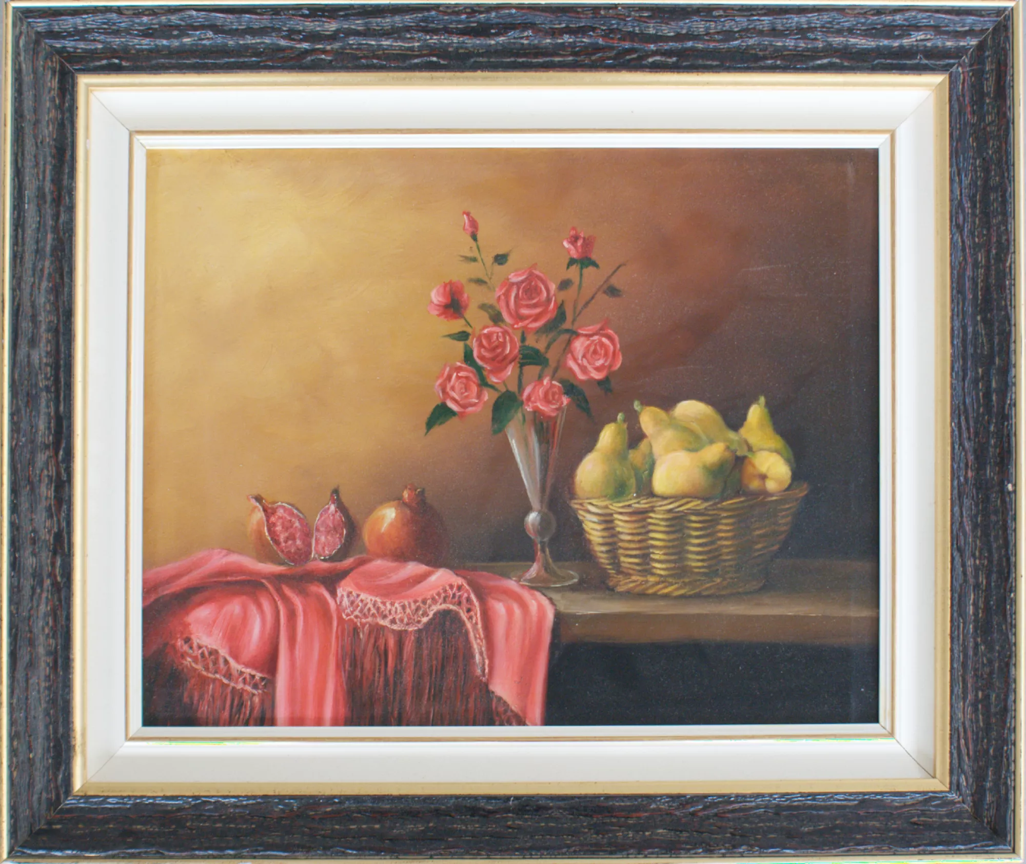 Still-life-with-pears,-roses,-and-pomegranates-Aly-Mohsen "Painting by Aly Mohsen, executed in Oil on canvas (brush). The title is Still life with pears, roses, and pomegranates and it belongs to the category Still Life. Original work by Aly Mohsen, this figurative still life is defined by a balanced composition and refined chromatic harmony, situating itself within the classical tradition of the genre while offering a measured and contemporary interpretation. On a horizontal surface, partially covered by a soft pink drapery with delicate embroidery, the artist arranges opened and whole pomegranates, a basket of ripe pears, and a floral composition of red roses placed in a slender glass vase. Soft, diffused light carefully models the volumes of the fruit and petals, establishing a dialogue between velvety surfaces, subtle transparencies, and natural materials. The warm, gently graduated background enhances spatial depth and gives the scene an intimate, contemplative atmosphere. Executed entirely with the brush, the painting demonstrates controlled and precise technique, emphasizing realistic detail while maintaining a cohesive and poetic visual unity. The organization of the elements follows a stable and legible structure, in which each object retains formal autonomy while contributing to the overall compositional balance. The presence of the drapery introduces a soft, dynamic element that guides the viewer’s eye and reinforces the relationship between the different spatial planes. The artwork is completed by a wide frame with dark finish and a light inner profile, which surrounds the composition with restraint and balance. The frame enhances the warm tonal range of the painting and reinforces its museum-style presentation, providing a coherent and formally resolved display."